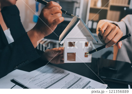 Close up Business people or Real Estate agent explain signing agreement for sale house to client. Property, Insurance, Broker concept. 121356889