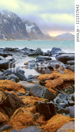 Waves of Norwegian sea on rocky coast in fjord on sunset. Vareid beach, Lofoten islands, Norway Waves of Norwegian sea on rocky coast in fjord on sunset. Vareid beach, Lofoten islands, Norway 121357642