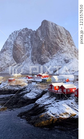 Hamnoy fishing village on Lofoten Islands, Norway with red rorbu houses. With falling snow in winter Hamnoy fishing village on Lofoten Islands, Norway with red rorbu houses. With falling snow in winter 121357650