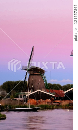 Windmills at famous tourist site Zaanse Schans in Holland in twilight after sunset. Zaandam, Netherlands 121357842