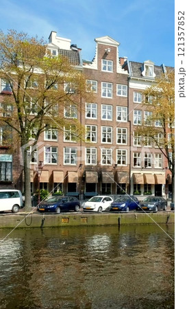 Amsterdam cityscape with canal, houses and boats. Amsterdam, Netherlands 121357852