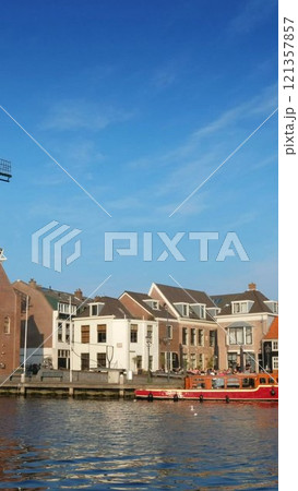 View of Harlem landmark windmill De Adriaan on Spaarne river. Harlem, Netherlands View of Harlem landmark windmill De Adriaan on Spaarne river. Harlem, Netherlands 121357857