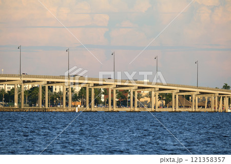 Barron Collier Bridge and Gilchrist Bridge in Florida with moving traffic. Transportation infrastructure in Charlotte County connecting Punta Gorda and Port Charlotte over Peace River Barron Collier Bridge and Gilchrist Bridge in Florida with moving traffic. Transportation infrastructure in Charlotte County connecting Punta Gorda and Port Charlotte over Peace River 121358357