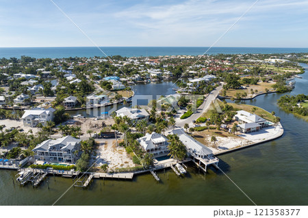 American waterfront houses in rural US suburbs. View from above of large residential homes in island small town Boca Grande on Gasparilla Island in southwest Florida 121358377