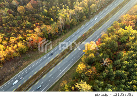 American highway in North Carolina Appalachian mountains in fall season with fast moving traffic. Interstate transportation concept American highway in North Carolina Appalachian mountains in fall season with fast moving traffic. Interstate transportation concept 121358383