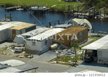 Aftermath of natural disaster in southern Florida. Badly damaged mobile homes after hurricane Ian swept through residential area 121358412