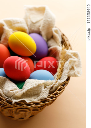 Happy Easer eggs in a basket 121358440