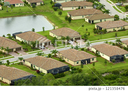 Aerial view of tightly located family houses in Florida closed suburban area. Real estate development in american suburbs 121358476