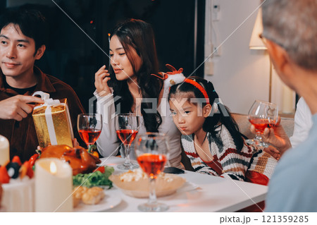 Merry Christmas! Happy family are having dinner at home. Celebration holiday and togetherness near tree. Merry Christmas! Happy family are having dinner at home. Celebration holiday and togetherness near tree. 121359285