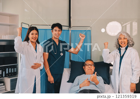A team of doctors and nurses are working to treat a female patient in the patient's room. A team of doctors and nurses are working to treat a female patient in the patient's room. 121359319
