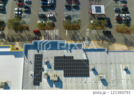 Aerial view of many photovoltaic panels installed on shopping mall roof top for producing of green ecological electricity. Production of sustainable energy concept 121360791