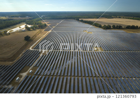 Aerial view of large sustainable electrical power plant with rows of solar photovoltaic panels for producing clean electric energy. Concept of renewable electricity with zero emission 121360793