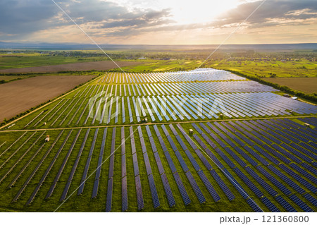 Aerial view of large sustainable electrical power plant with many rows of solar photovoltaic panels for producing clean ecological electric energy. Renewable electricity with zero emission concept. 121360800