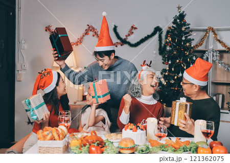 Happy family with gifts celebrating Christmas together Happy family with gifts celebrating Christmas together 121362075
