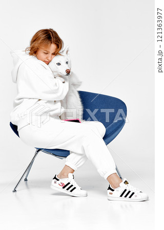 Woman Hugging Her Husky Companion 121363977