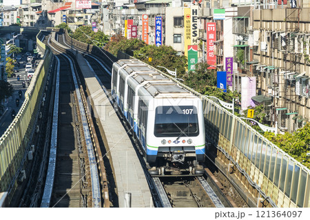 View of a Wenhu or Brown line train running on the elevated track of the Taipei Mass Rapid Transit System with the building background. View of a Wenhu or Brown line train running on the elevated track of the Taipei Mass Rapid Transit System with the building background. 121364097