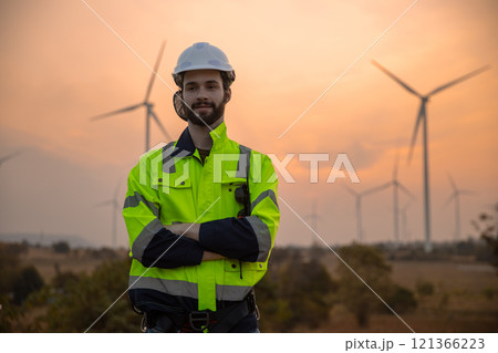 man engineer worker wearing safety uniform holding and reading blueprint working about renewable energy at station energy power wind. technology protect environment reduce global warming problems. man engineer worker wearing safety uniform holding and reading blueprint working about renewable energy at station energy power wind. technology protect environment reduce global warming problems. 121366223