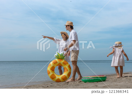 Family happy walking on beach children mother father travel summer vacation together sea holiday tropical. Trip enjoying bonding. 121366341