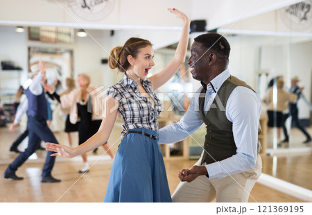 Pair dancing lindy hop during rehearsal Pair dancing lindy hop during rehearsal 121369195