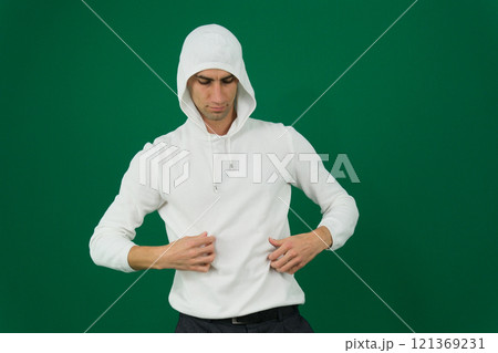 Full length portrait of man in hoodie sweater on light background. Space for design Full length portrait of man in hoodie sweater on light background. Space for design 121369231
