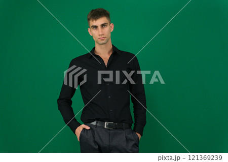 Man wearing black t-shirt on light grey background, closeup. Mockup for design Man wearing black t-shirt on light grey background, closeup. Mockup for design 121369239