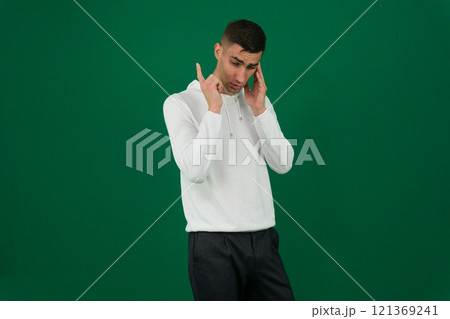 young man telephone gesture emotions of a handsome man guy on a green background chromakey close-up dark hair young man 121369241