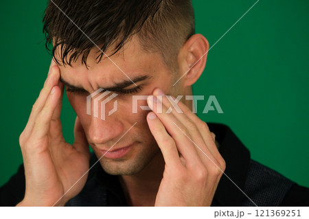 Unhealthy man suffering from migraines or dizziness sits on the couch at home, feels pain in his head. He is stressed, experiencing vertigo or headache, worrying about work or relationship problems. Unhealthy man suffering from migraines or dizziness sits on the couch at home, feels pain in his head. He is stressed, experiencing vertigo or headache, worrying about work or relationship problems. 121369251