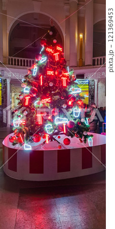 New Year tree at Odessa railway station. A bright red New Year tree inside the Odessa railway station. New Year tree at Odessa railway station. A bright red New Year tree inside the Odessa railway station. 121369453