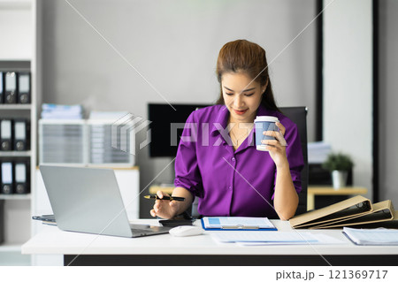 Business woman working at office with laptop and documents on desk, financial adviser analyzing data Business woman working at office with laptop and documents on desk, financial adviser analyzing data 121369717