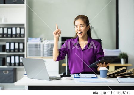 Business woman working at office with laptop and documents on desk, financial adviser analyzing data Business woman working at office with laptop and documents on desk, financial adviser analyzing data 121369752