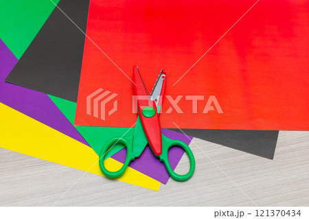 Colorful zigzag scissors with color paper isolated on white 121370434