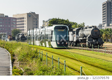 The circular light rail train drives past Hamasen Railway Cultural Park in Kaohsiung, Taiwan. The circular light rail train drives past Hamasen Railway Cultural Park in Kaohsiung, Taiwan. 121370570