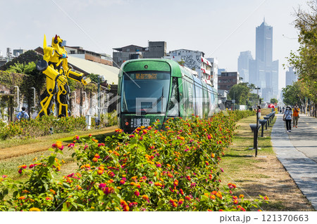The circular light rail train drives past Pier-2 Art Center in Kaohsiung, Taiwan. 121370663