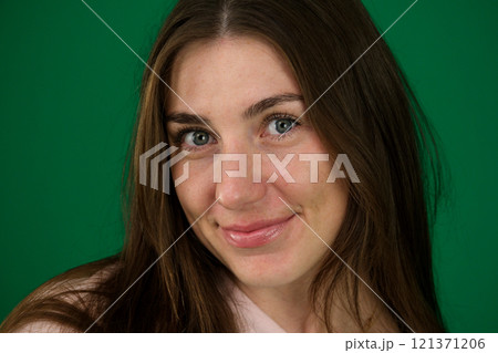 Close up face of young woman with beautiful smile isolated on grey wall with copy space. Successful multiethnic girl. Latin woman looking at camera against gray wall with a big whitening teeth smile. 121371206