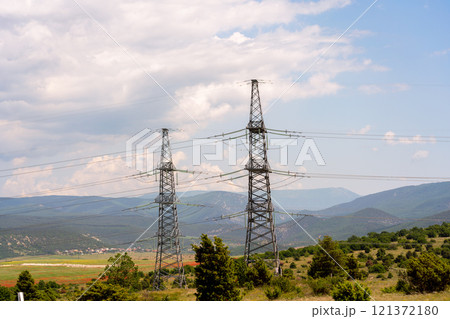 High voltage towers Electric pole. Power line support with wires for electricity transmission. High voltage grid tower with wire cable at distribution station. Energy industry, energy saving High voltage towers Electric pole. Power line support with wires for electricity transmission. High voltage grid tower with wire cable at distribution station. Energy industry, energy saving 121372180