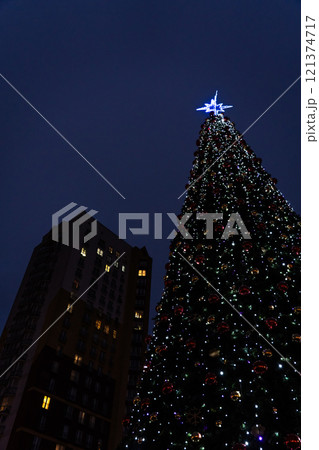 New Year's tree on the background of a multi-storey building 121374717