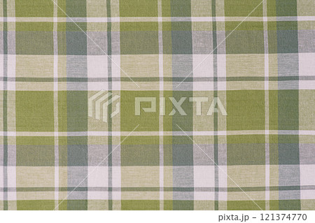 Green and white checkered fabric as a background. Green and white checkered fabric as a background. 121374770