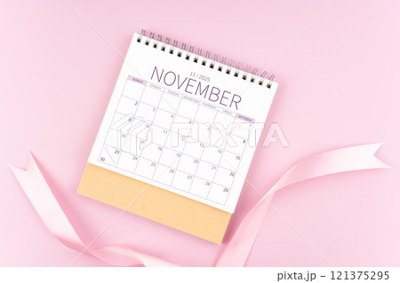 November 2025 desk calendar with pink pastel ribbon. November 2025 desk calendar with pink pastel ribbon. 121375295