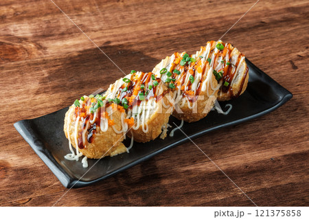 Fried Sushi Rolls with Sauce and Tobiko 121375858