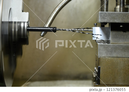 The lathe machine drilling process the metal parts. 121376055