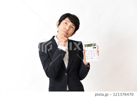 電卓を持ち困るスーツ姿の中高年の女性 121376470