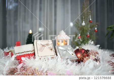 Christmas gift box with ornament and decoration on white table with small pine tree 121376688