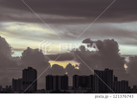 Silhouette view of Modern high-rise buildings and background of Dramatic sky in the city of Bangkok. Silhouette view of Modern high-rise buildings and background of Dramatic sky in the city of Bangkok. 121376743