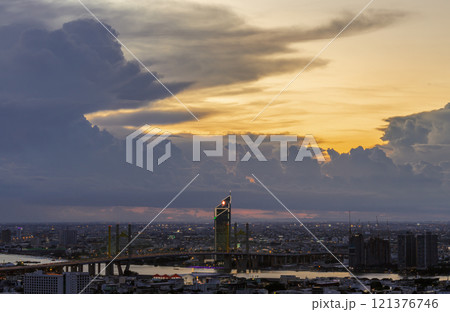 Beautiful skyscrapers view and the Bridge crosses the Chao Phraya river of Bangkok city with Dramatic sky background at before sunset. 121376746