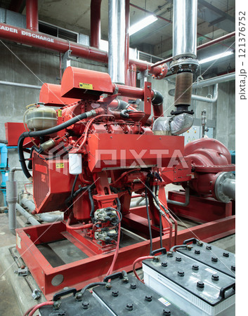 Fire protection system of Condominium. Red generator pump for water sprinkler piping and Fire alarm control system. 121376752