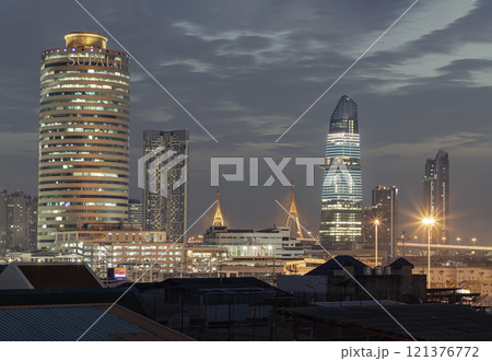 Stunning view of Skyscrapers in the business district with bright glowing lights in the night. 121376772