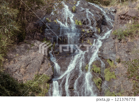 Waterfall stream falling down rocks and stones of mountain steep slope. Tropical forest in Sarika waterfall is the landmark national park of at Nakhon Nayok province, 121376778