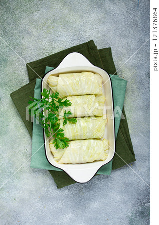 raw cabbage rolls, not cooked, with minced meat, top view, without people, in the spotlight. 121376864