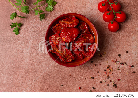dried tomatoes, in a bowl, top view, on a brown background, dried tomatoes, in a bowl, top view, on a brown background, 121376876