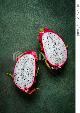 Dragon fruit, pitahaya, one piece, cut, top view, rustic style, green background, 121376916